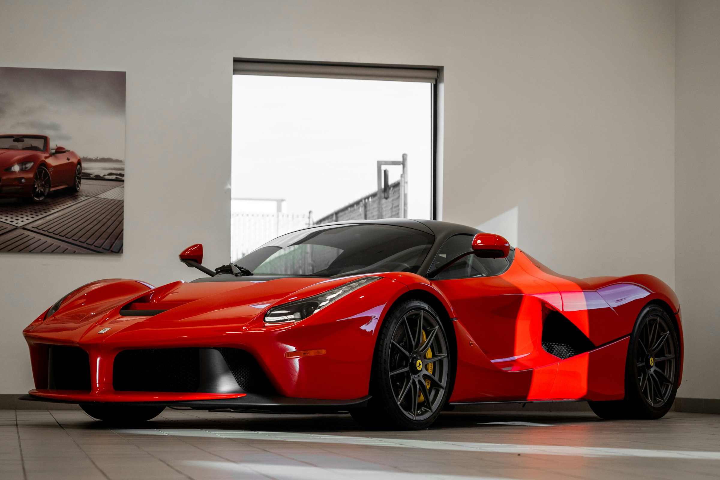 Red supercar in a bright showroom