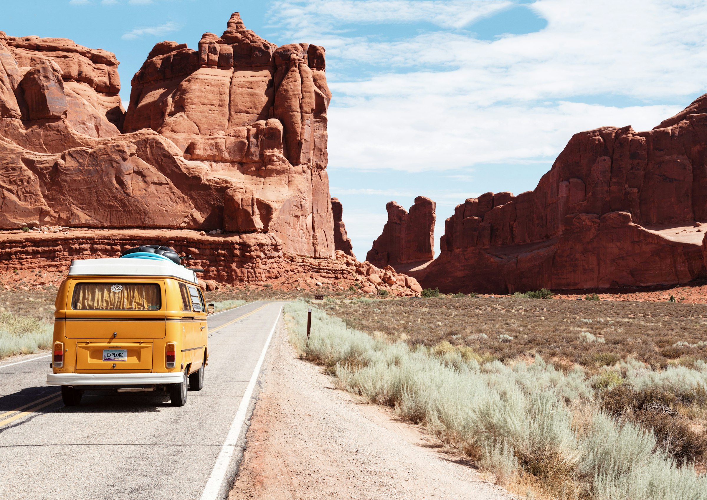 Van driving through a red-rock canyon